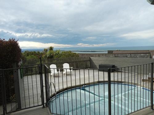 a swimming pool on a balcony with a fence at Mount Pleasant Views in Christchurch
