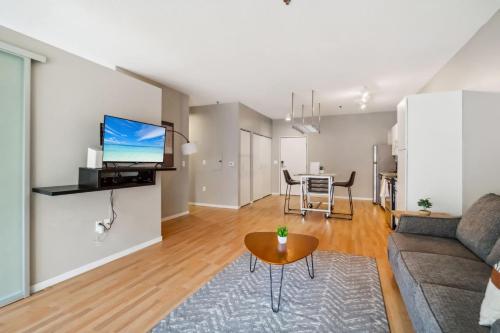 a living room with a couch and a table at CozySuites Mill District with pool, gym #08 in Minneapolis