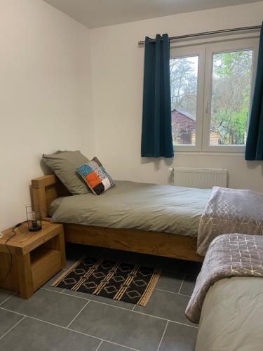 a bedroom with a bed and a window at Un jardin en forêt in Samois-sur-Seine