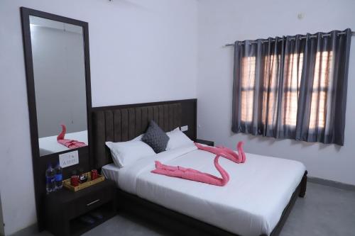 Un dormitorio con una cama con zapatillas rosas. en Rajwada Fort, en Dabok