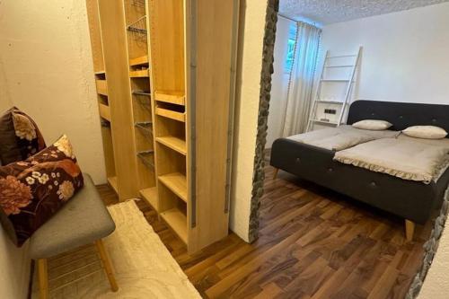 a small room with a bed and a closet at Sunway Lounge in Maishofen