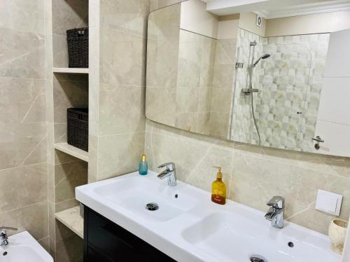 a bathroom with a sink and a shower at Antonio’s Captain Apartment - 200m from the beach in Peniche