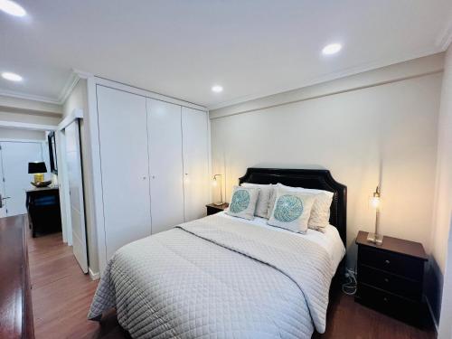 a bedroom with a large bed with two pillows at Antonio’s Captain Apartment - 200m from the beach in Peniche