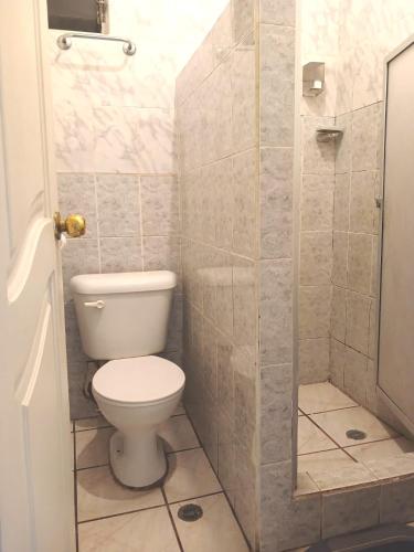 a bathroom with a toilet and a shower at Hostal Almagro in Quito