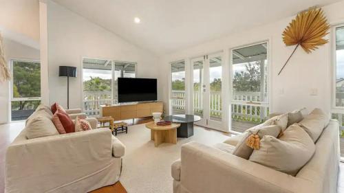 a living room with two couches and a flat screen tv at The Birkdale with Heated Pool by Ready Set Stay - BYO Linen and Towels in Sunset Strip