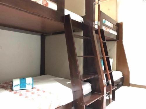 a bunk bed with a ladder in a room at Weekends El Nido Beach Resort in El Nido