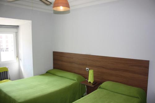 Ένα ή περισσότερα κρεβάτια σε δωμάτιο στο Hostal La Estación