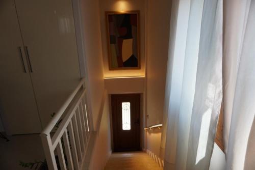 a stairway with a door and a window at Villa Vaso with jacuzzi in Epanomi