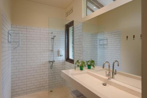 a bathroom with a sink and a shower at Ashtari - Sky, Sea & Nature in Kuta Lombok