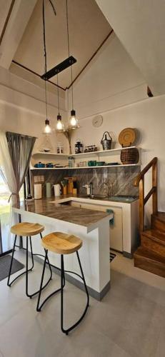 a kitchen with two stools and a counter in a room at Tiny beach house, Private vacation home in San Francisco