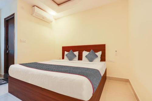 a bedroom with a large bed with two pillows at Gokul Pride in Hyderabad