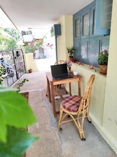 a laptop computer sitting on a table on a patio at Park View in Mysore