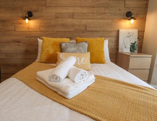 a bedroom with a bed with towels on it at Tow Beds, Close to Town, Beach, Hospital, Free Parking in Eastbourne