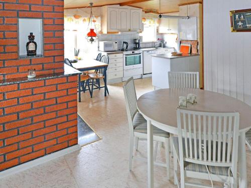 a kitchen and dining room with a table and chairs at Summer cottage near the beach in Mellbystrand