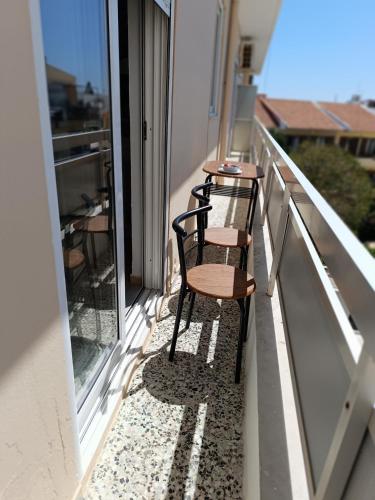 a row of benches sitting on a balcony at Nautilus City Studios & Apartments in Rhodes Town