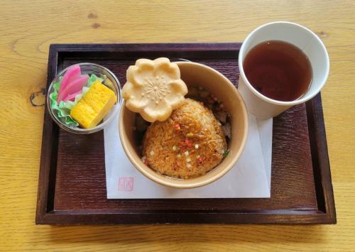 a plate with a bowl of food and a cup of tea at Prince Smart Inn Atami in Atami