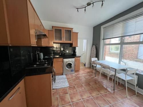 a kitchen with a table and a dining room at 3 Bedroom Apartment, Flat in London in Forest Hill