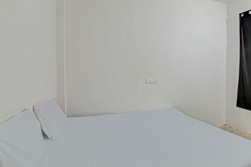 מיטה או מיטות בחדר ב-OYO Arnav Guest House