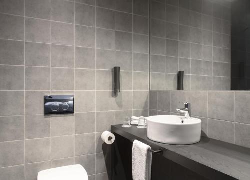 a bathroom with a sink and a toilet at Skuggi Hotel by Keahotels in Reykjavík