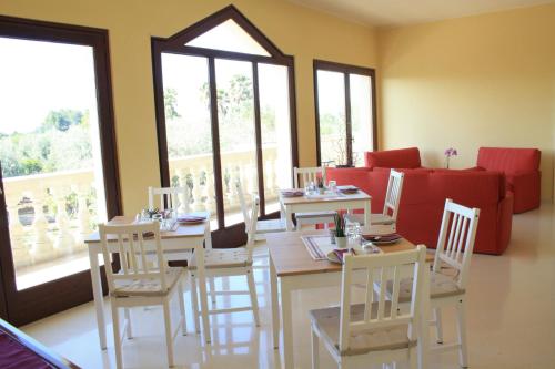 a living room with a table and chairs and a couch at Relais il Melograno in Arnesano