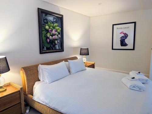 a bedroom with a bed with a phone on it at ONE Luxury Apartment in Devonport