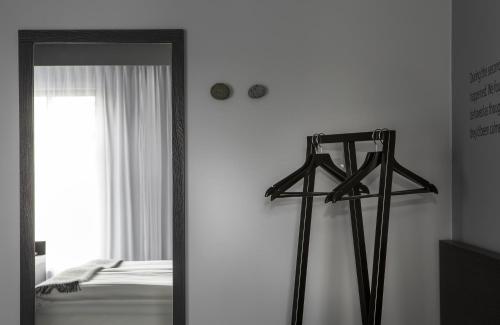 a mirror in a room with a bed and a window at Skuggi Hotel by Keahotels in Reykjavík