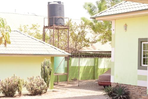 a view of a house with a silo in the background at Royal Suites And Apartments FHA in Jidu