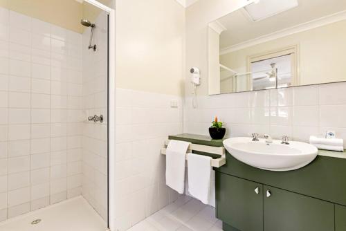 a bathroom with a sink and a shower at Island Breeze Resort in Cowes