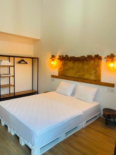 a bedroom with a large white bed with two pillows at Çıralı Marina Loft in Cıralı