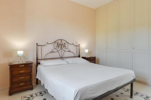 a bedroom with a large bed and two night stands at Relais il Melograno in Arnesano