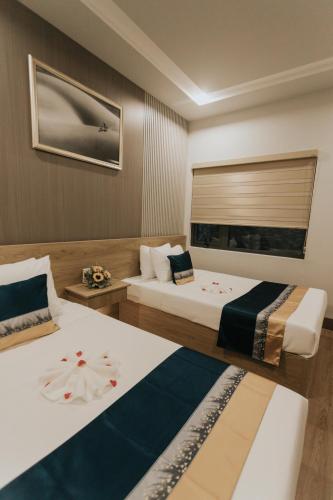 Postel nebo postele na pokoji v ubytování Khoa Hotel Phan Thiết