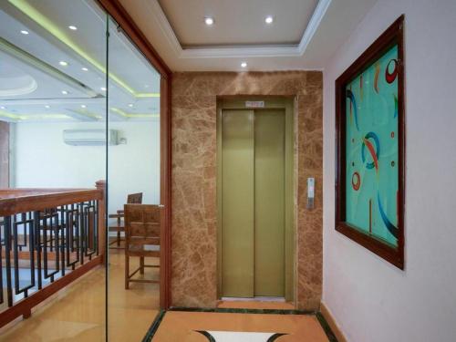 a hallway with a glass elevator in a building at Umed in Jodhpur