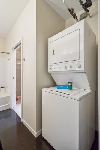 a white washer and dryer in a room at CozySuites 2BR Mill District with pool, gym #04 in Minneapolis