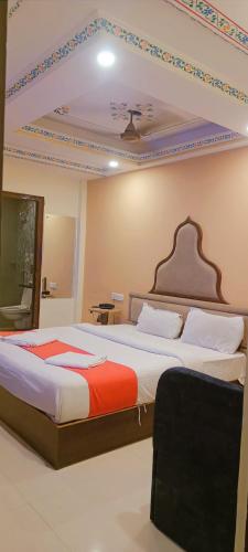 a bedroom with two beds and a ceiling at Umed in Jodhpur