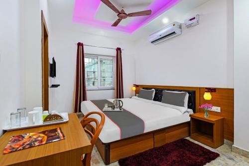a bedroom with a bed and a desk and a table at Collection O D N Grand in Rānchī