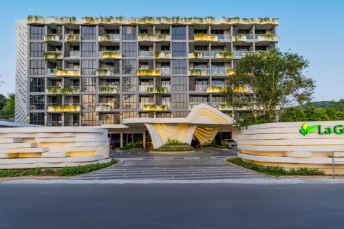a large apartment building with a slide in a parking lot at La Green Hotel and Residence in Bang Tao Beach