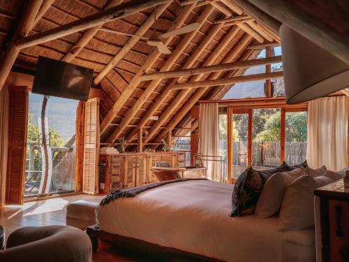 a bedroom with a large bed and a large window at Wonderland in Hout Bay