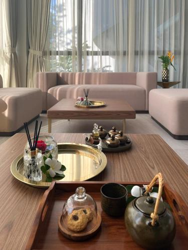 a living room with a couch and a table at La Green Hotel and Residence in Bang Tao Beach