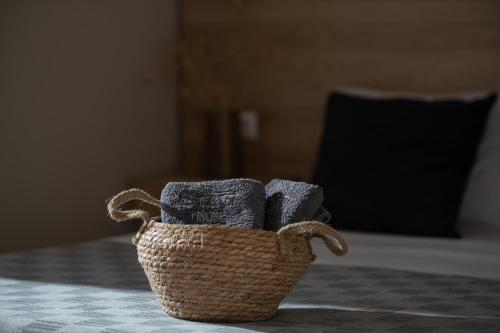 a basket of towels sitting on top of a table at StayInn Luxury Apartments in Nea Kalikratia