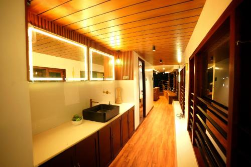 a bathroom with a sink and a counter top at IndraprasthamLakeCruise in Alleppey