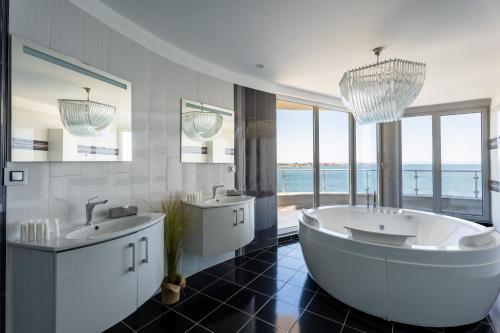 a large bathroom with two sinks and a large tub at The LODGE Summer Apartments Sozopol in Sozopol