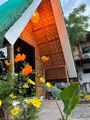 a building with flowers in front of it at Villa Lovi Panagsama Beach Moalboal in Moalboal