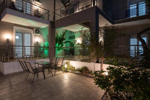 a patio with chairs and a table in a building at StayInn Luxury Apartments in Nea Kalikratia