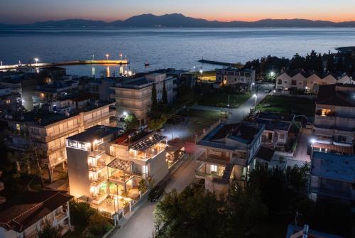 an aerial view of a city at night at StayInn Luxury Apartments in Nea Kalikratia