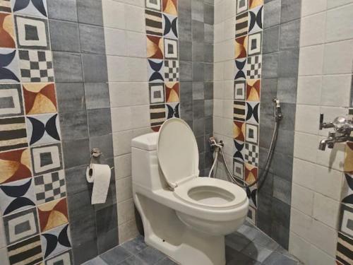 a bathroom with a white toilet in a room at Hotel Olive Branch Darjeeling Near Mall Road - Excellent Customer Service - Parking Facilities - Best Seller in Darjeeling