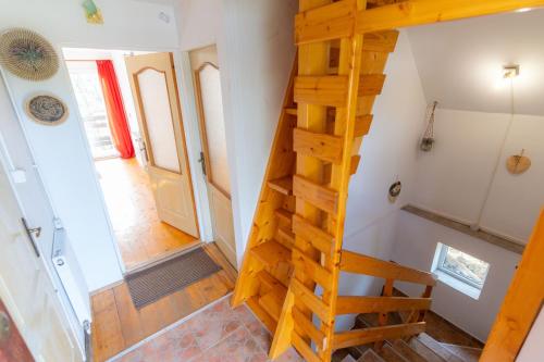 a staircase leading up to the loft room of a tiny house at House Jakob Camping Ananas Cisnadioara in Cisnădioara