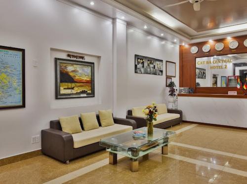 a living room with couches and a coffee table at Catba Central Hotel 2 in Cat Ba