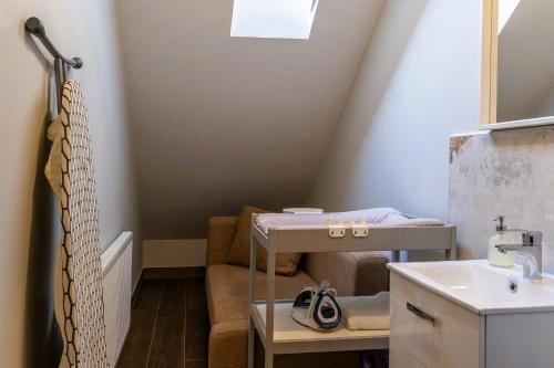 a small attic bathroom with a sink and a sink at Złota Jesień Restauracja i Noclegi nad jeziorem in Kartuzy