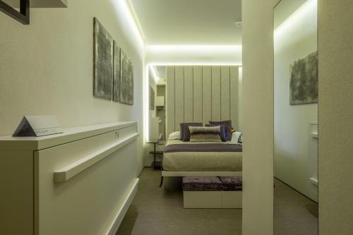 a bedroom with a bed in a room at Room 230 Roma Luxury Suites in Rome
