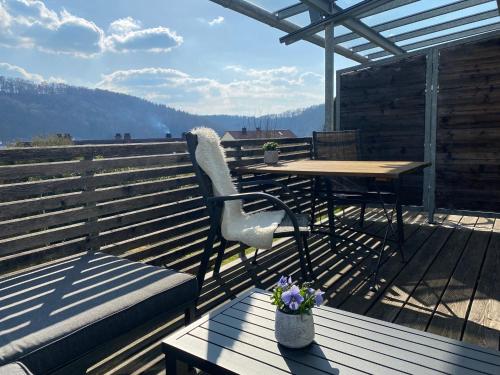 a chair and a table on a wooden deck at Ferienhaus Meixner in Riedenburg